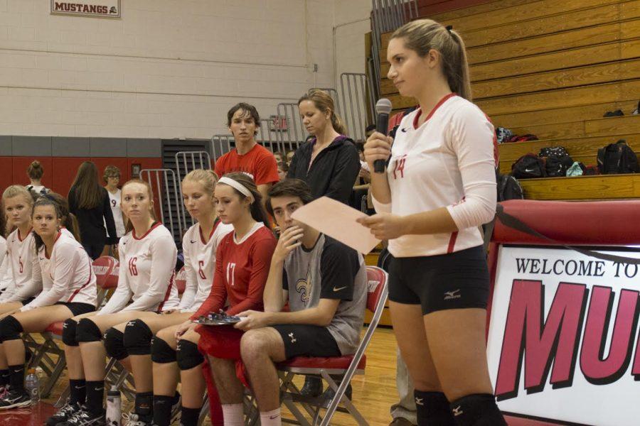 Senior Juila Loverde reads a speech before the volleyball game in remembrance of Mrs. Craven. 