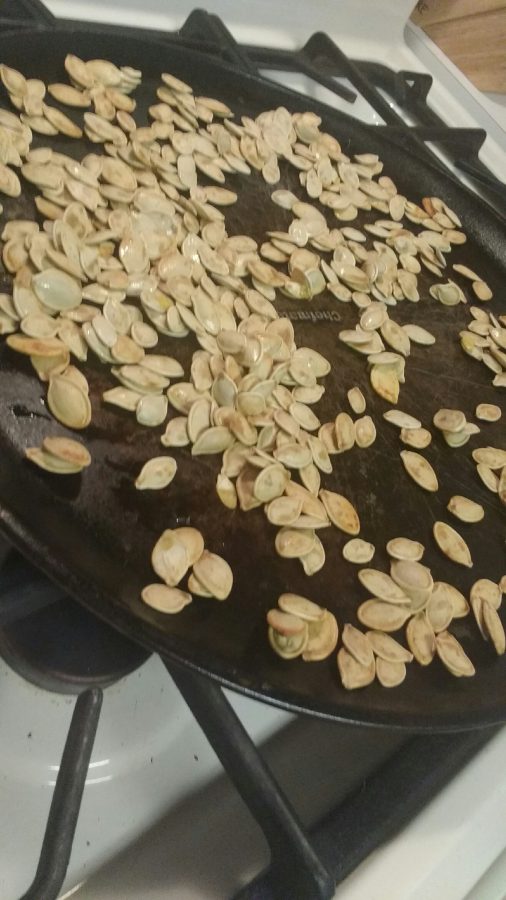 Pumpkin seeds spread evenly over the pan.