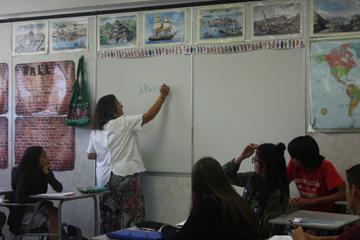 Social Studies Teacher Susan Theotokatos demonstrates an activity for her students.