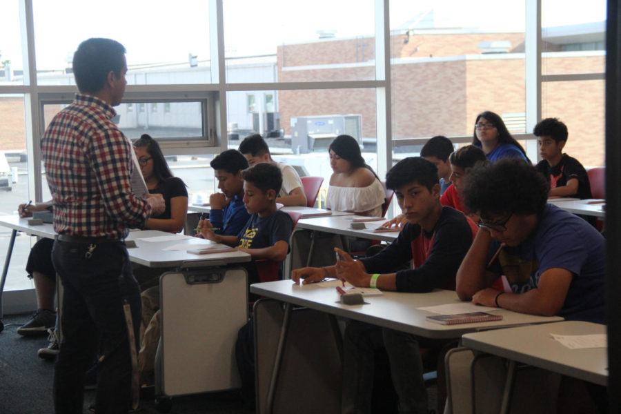 Spanish teacher Brian Packowitz lectures Spanish class as students look on and take notes