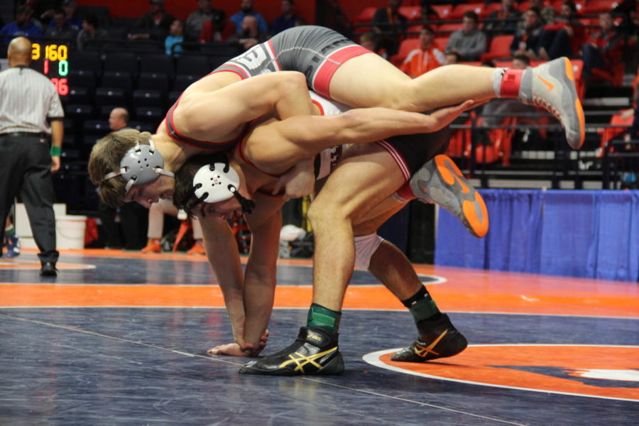 Hard Work: Junior Logan Kvien loses to sophomore Nick Stemmet of Yorkville High School in his quarterfinal round at 182 pounds at the IHSA Individual State tournament in Champaign.