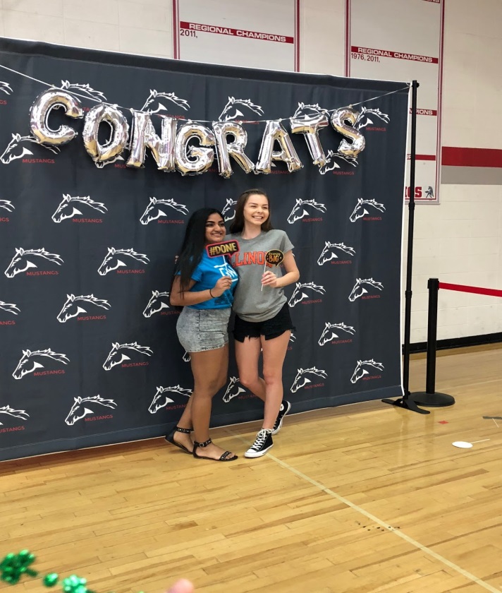 At the Decision Day celebration, seniors Natasha Kumar and Kendall Job pose for a picture. The celebration included various photo backdrops for the students’ use set up by the student college ambassadors.