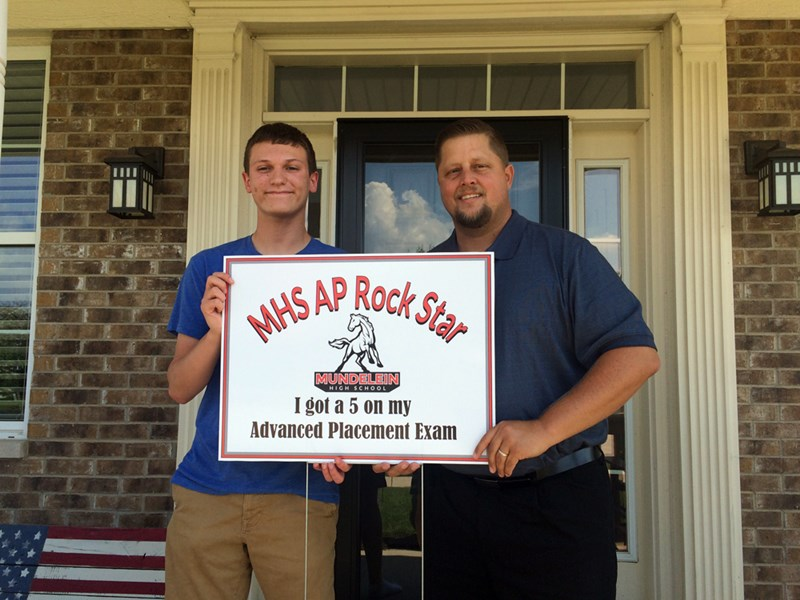 During his sophomore year, Senior Charles Fladhammer received a 5 on the AP U.S. History exam. Those who receive a 5 on an AP exam receive the above yard sign delivered by a school administrator. In this case, Fladhammer was visited by the Director of the Guidance Department Tom Buenik. Fladhammer said, “U.S. history has always been my strong suit, but I think in particular it was because the test was primarily about World War II and the Cold War, which are areas I think I strive in in history.”
 
