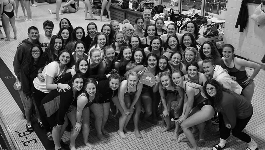 Varsity and JV swimmers and divers celebrate their victory against Warren Township High School, which placed the varisity team in third place and the JV team in second place in the conference.