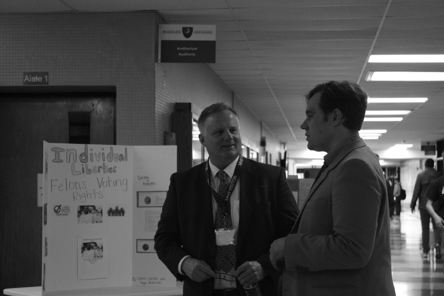 Lake County Circuit Judge Christopher Morozin speaks with a campaign aid for Dr. Tom Tarter, a Republican candidate for U.S. senator, as they tour the Civics Fair held in the Commons by AP Government students on March 5 during the lunch periods.