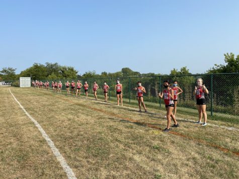 At the first meet of the season, girls cross country lines up ready to run on Aug. 25 at the Diamond Lake Sports Complex. While meets are more like time trials this season than previous seasons, the girls said they are still excited for the season. Hope Peterson, senior, said, “We love what we do.”