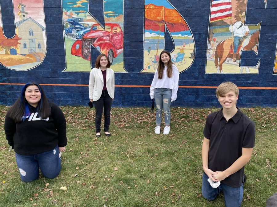 In a heated tent outside of Area Coffee in Mundelein, senior Rosy Castro, freshman Kai Ackerman, freshman Gianna Feather and junior Eli Walter film “Something In Common,” a play by Robin Pond, directed by Castro. This play, along with 11 others, will stream on Dec. 12 and 13 for virtual audiences.