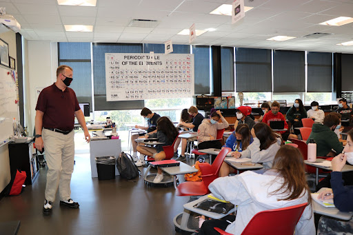 Science Teacher Chris Michalides teaches his third period Honors Chemistry class, discussing how the metric system functions. He said he has looked forward to a return to in-person learning, to go back to the teaching style he had before remote learning. “I can monitor more students accurately and conveniently when in person,” he said. “Science is inherently hands-on for students and for me. Time to bring back the cool and dramatic demonstrations that make science interesting for many.”