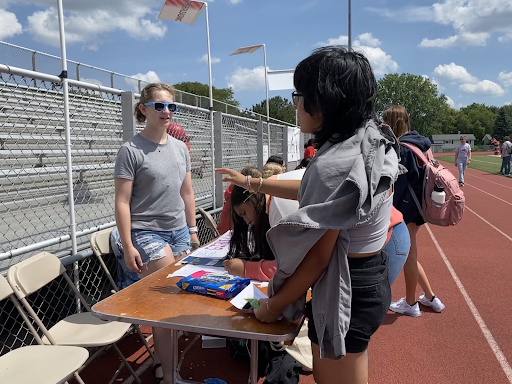 Hello world of coding: Senior Jill Kennicott (left) encourages Sophomores Enayda Bustos and Sarai Herrera to sign up for the club Girls Who Code. Despite expressing hesitancy at first, Bustos and Herrera eventually opened up the idea of trying something new. “[Kennicott] was like: ‘oh no, you don’t need any experience’,” said Bustos. “She got us more confident in ourselves.”