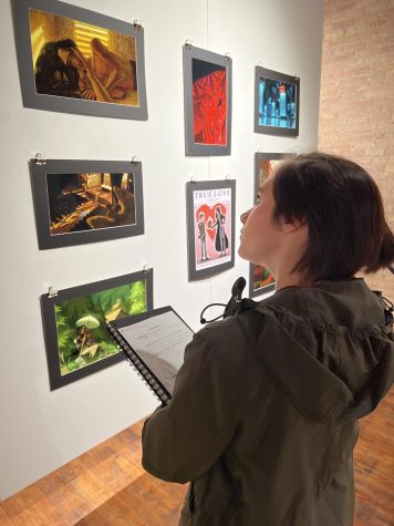 Junior Rey Palacios looks at student artwork at the Bridgeport Art Center which hosted the IHSAE.